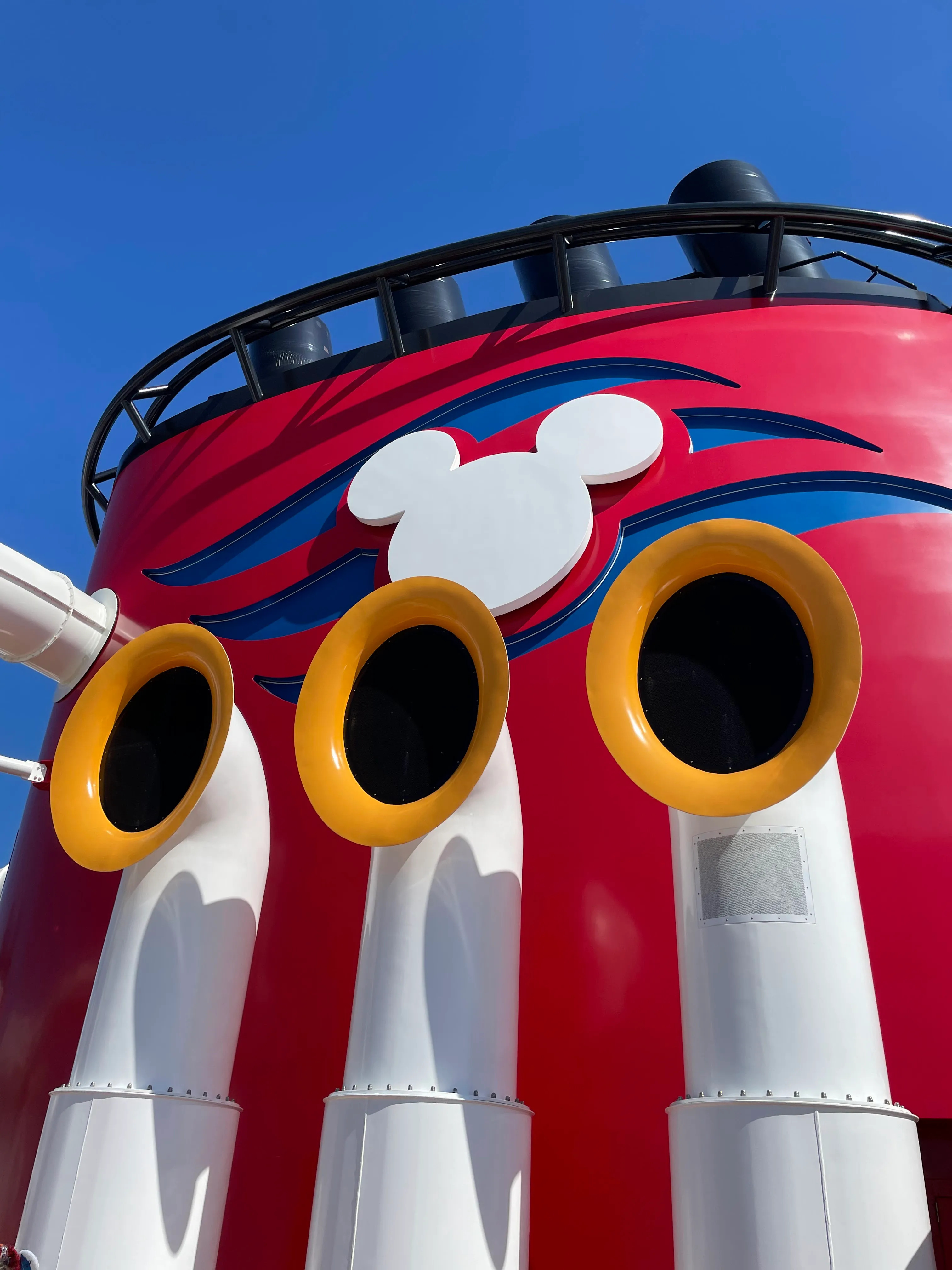 A photo aimed towards the sky of a Disney cruise ship smokestack